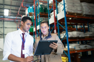 digital inventory employees working in a modern warehouse