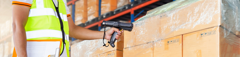 warehouse worker scanning a pallet of box