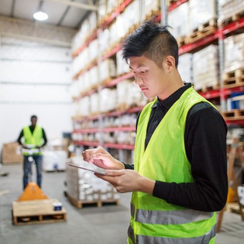 warehouse worker uses cutting-edge mobile warehouse software on a wireless device
